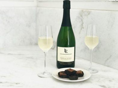 Bottle of Lucas & Lewellen Sparkling Wine with chocolates