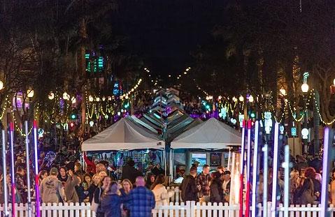 Image of Ventura Wine Walk at night, crowd gathering for holiday festivities