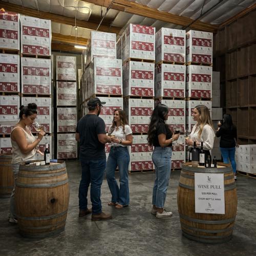 People standing in front of cases of wine - Wine Pull warehouse wine sale People standing in front of cases of wine - Wine Pull warehouse wine sale
